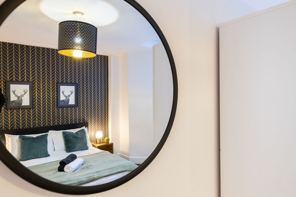 Bedroom reflected in the mirror in the two bedroom Reading apartment