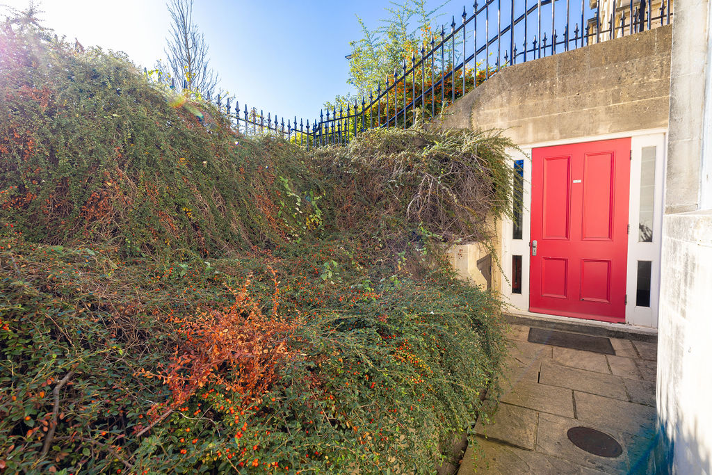 Red entrance door and steps in the two bedroom Reading apartment