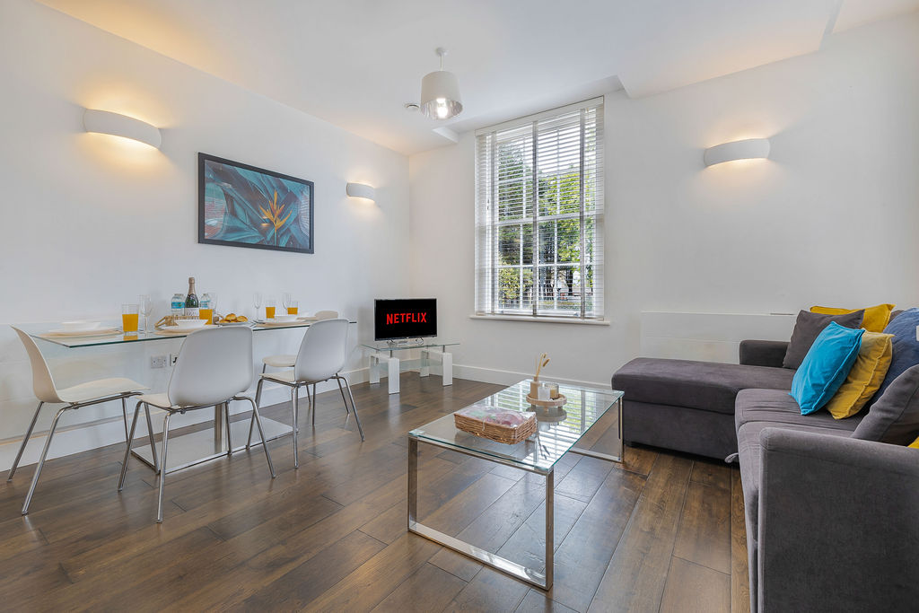 Living area with TV in the three bedroom Reading apartment
