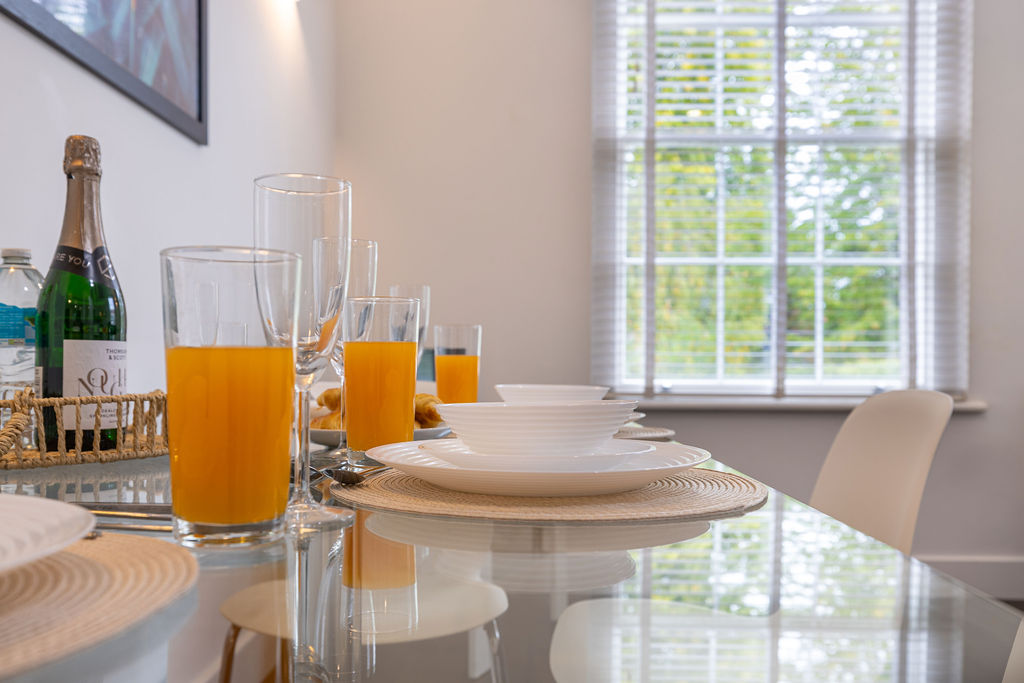 Dining table beside the window in the three bedroom Reading apartment