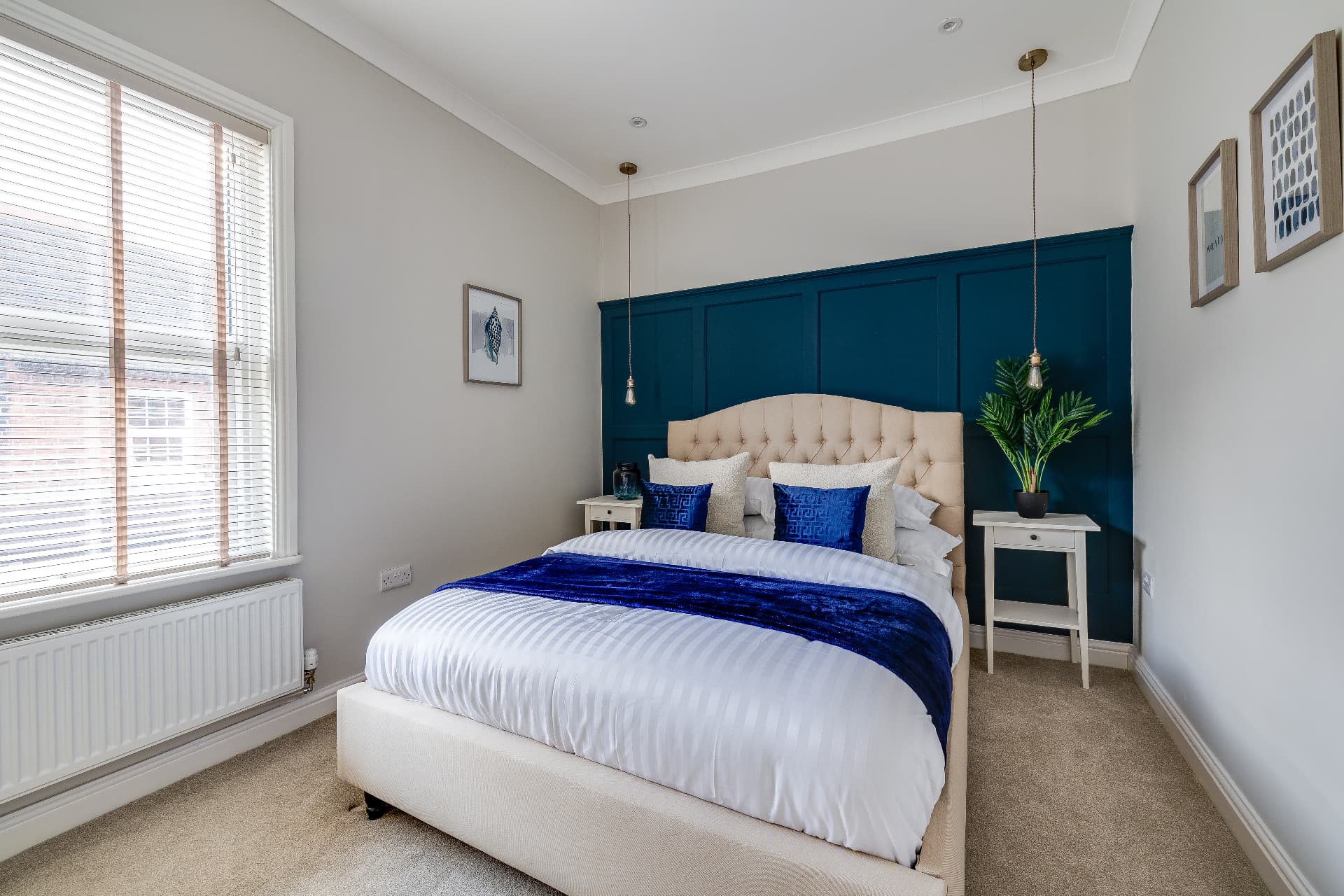 Second bedroom with teal feature wall in the two bedroom Chester property