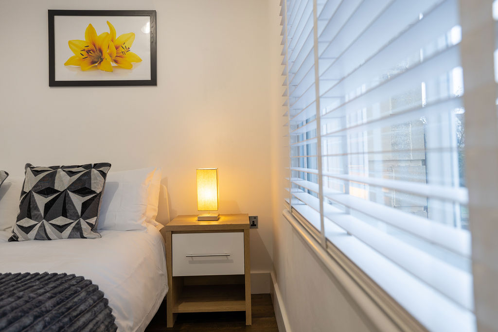 Second bedroom bedside lamp in the three bedroom Reading apartment